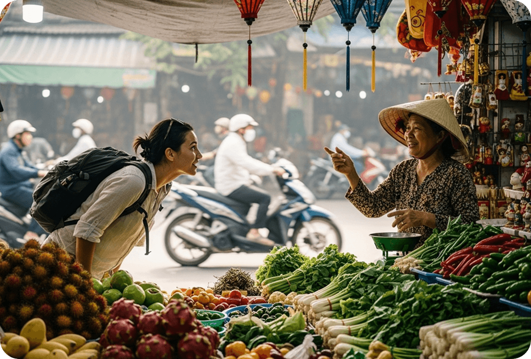 A traveler speaking Vietnamese with a street vendor at a bustling market in Hanoi’s Old Quarter.